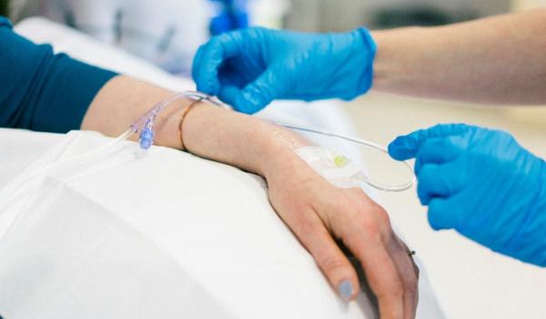 Close up of a nurse inserting a drip for chemotherapy