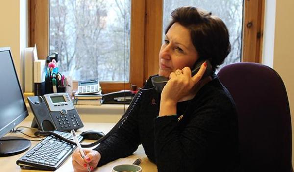 Target Ovarian Cancer Nurse Adviser, Val Lang, on the phone listening and taking notes