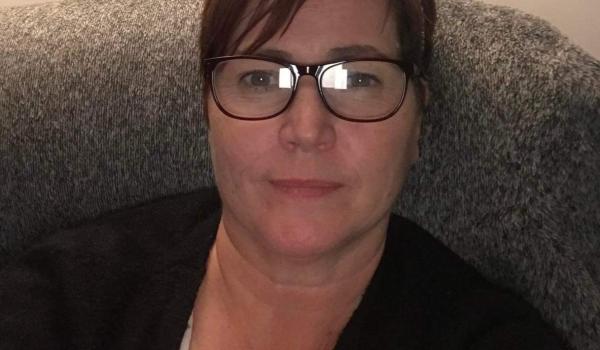 A selfie of sitting on the sofa smiling