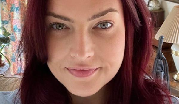 A selfie of Kate with long hair front on to camera