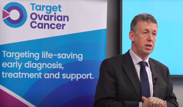 Professor Richard Edmondson speaking at an event in front of a Target Ovarian Cancer banner