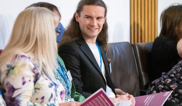 An image of Rob Hollis talking to someone at our Pathfinder event in Scottish Parliament