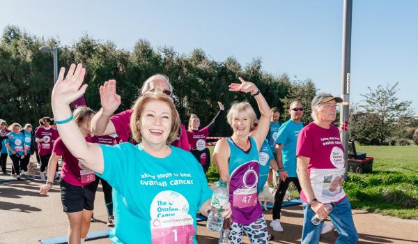 Sue taking part in the Walk Run in 2022 walking by the side of Target Ovarian Cancer CEO, Annwen Jones, both wearing charity t-shirts