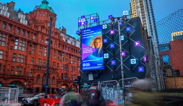 Natalie Wild featuring in an ovarian cancer symptoms billboard in Old Street