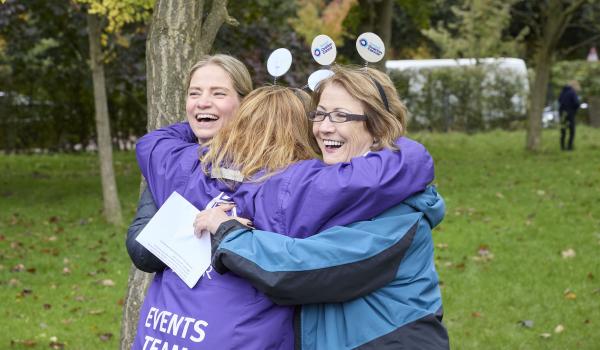 A photo of Annwen in an embrace with fellow Target Ovarian Cancer staff members