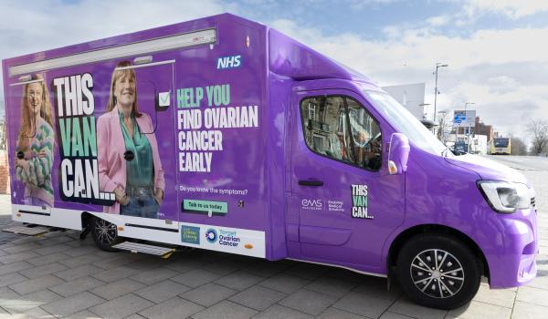 A photo of a purple van which has the words This Van Can on the side and photo of two women