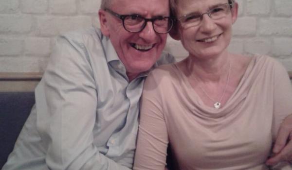 A photo of Stephen and Julie with their arms round each other smiling together