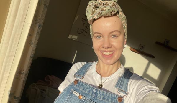 A photo of Claire wearing a headscarf smiling