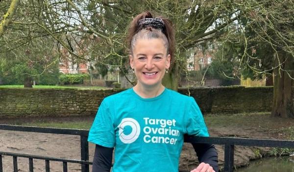 Lisa standing outside wearing a teal coloured Target Ovarian Cancer tshirt