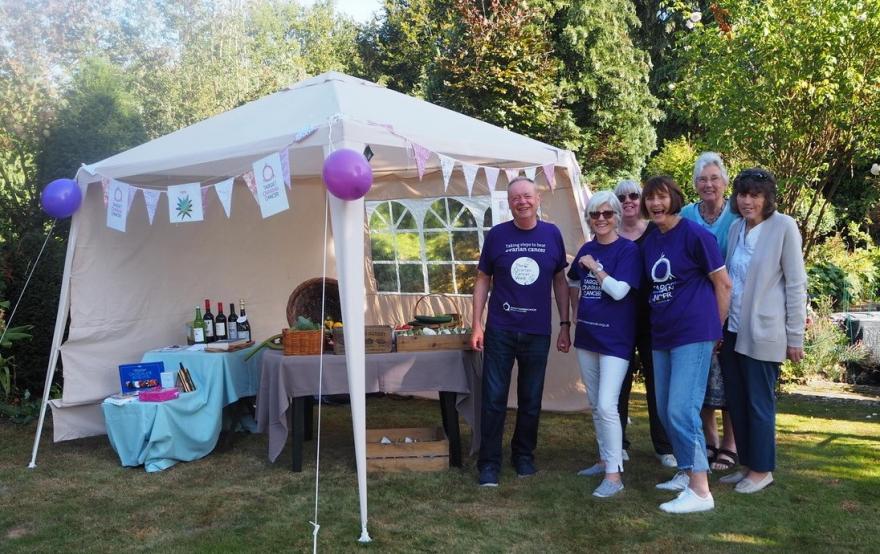 Family and friends enjoying a raffle in a garden while raising money Target Ovarian Cancer