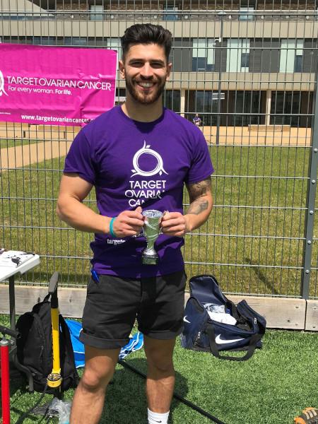Target Ovarian Cancer fundraiser, Giorgio, holding a small football tournament trophy