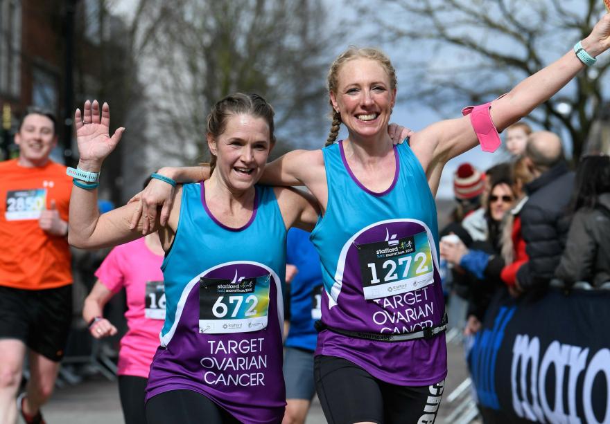 Two Target Ovarian Cancer fundraisers running and waving