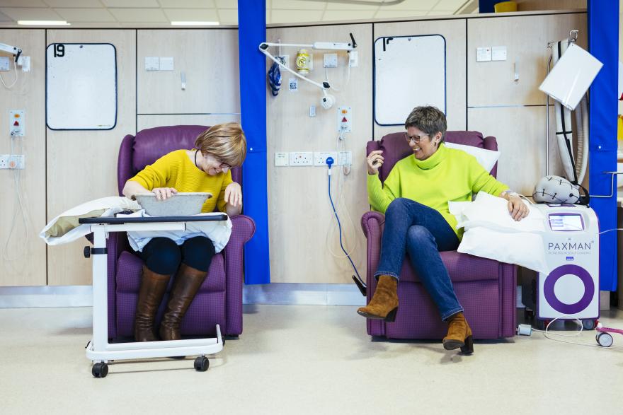 Two women laughing during chemotherapy