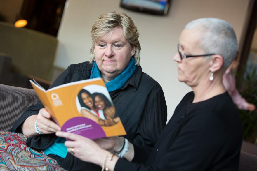 Two women reading a guide