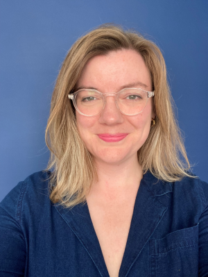 A headshot image of Kate Martin on a blue background