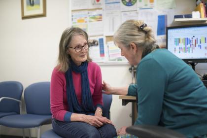 A woman is comforted by a GP in the GP's office