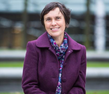 Headshot of campaigner, Christine, wearing a purple coat and smiling