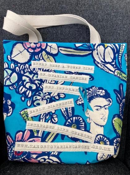 A blue bag displaying ovarian cancer statistics and information