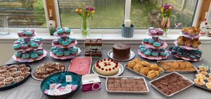 Table full of cakes and cupcakes