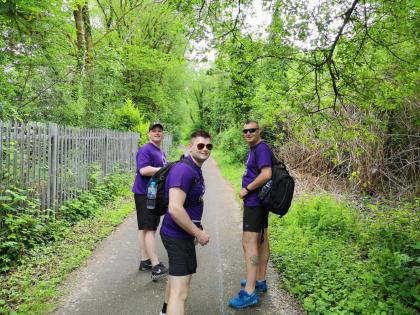 Three Target Ovarian Cancer fundraisers wearing purple t-shirts walking to raise money