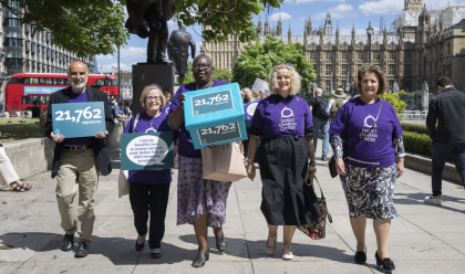 Della and other campaigners march in Parliament Square