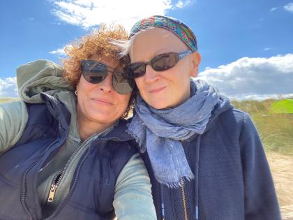 Anne and her partner taking a selfie in the sun 