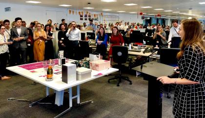 A group of colleagues in an office holding a raffle