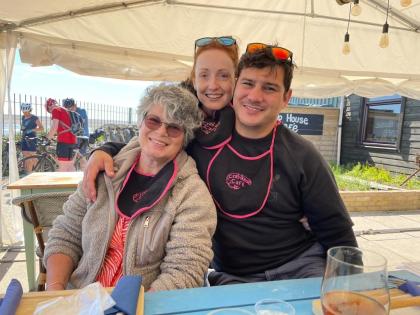 Tracy and her son and daighter-in-law smiling on holiday