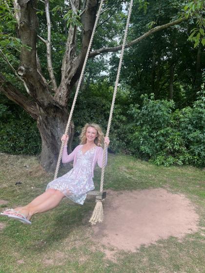 Charlotte on a swing in the woods