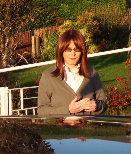 A photo of Amanda in October 2016 a month before her diagnosis sat outside in the garden
