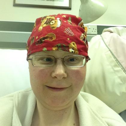 Amanda in hospital wearing a headscarf and smiling whilst undergoing treatment for chemotherapy 2017