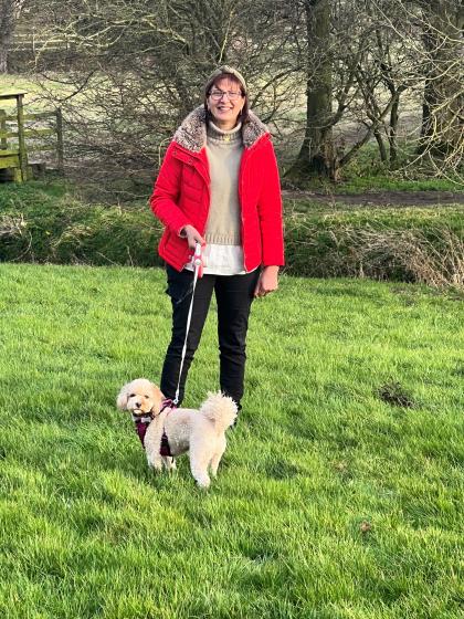 Anita in a field walking her dog