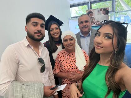 Sbba and her husband, two daughters and son at her daughters graduation ceremony