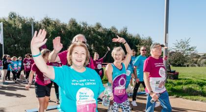 Sue taking part in the Walk Run in 2022 walking by the side of Target Ovarian Cancer CEO, Annwen Jones, both wearing charity t-shirts