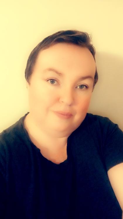 A selfie of Grainne wearing a black top with short hair