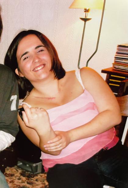 Leanne smiling at camera wearing a pink top