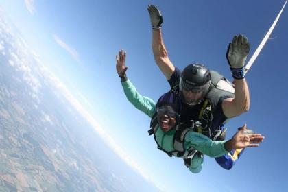 Shaniqua skydiving with her arms out the side
