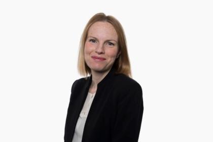 A photo of Sonya Branch waring a white top and black blazer jacket looking towards the camera