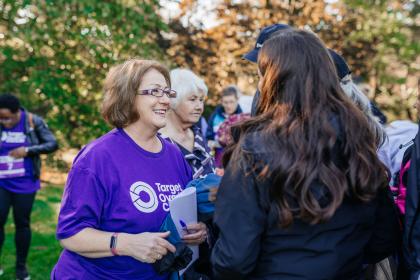 Annwen talking to the Target Ovarian Cancer supporters wearing a purple Target Ovarian Cancer tshirt