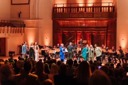 A photo of the performers on stage at Playing Our Part