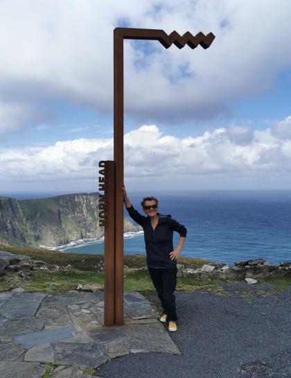 Jenny standing on a cliff with a view of the sea in Donegal, Northern IReland