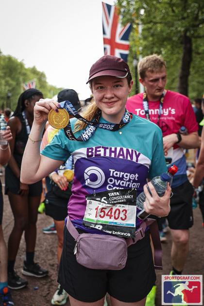 Bethany after finishing the London Marathon wearing her medal and Target Ovarian Cancer running tshirt