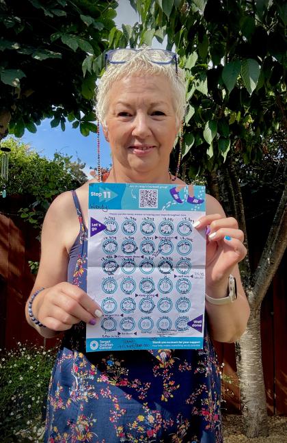 Wendy holding up her step counting chart whilst taking part in the Step 11 challenge