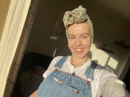 A photo of Claire wearing a headscarf smiling