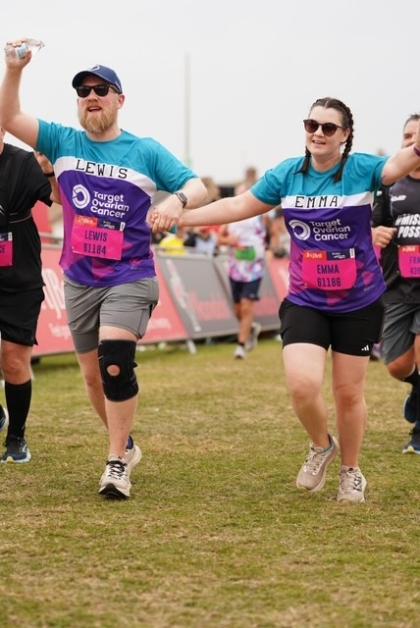 A photo of Lewis and Emma running hand in hand at the Great North Run