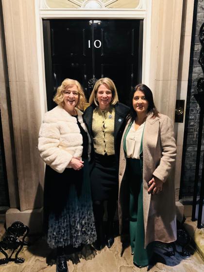 An image of Catherine, Catherine Hart (Target Ovarian Cancer CEO) and Reeta standing outside the black door of number 10 Downing Street