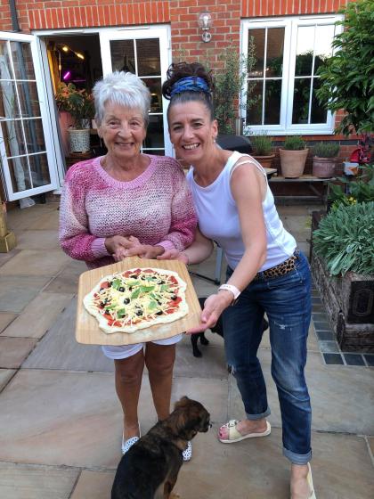 A photo of Lisa and her mum pat standing in the garden together smiling