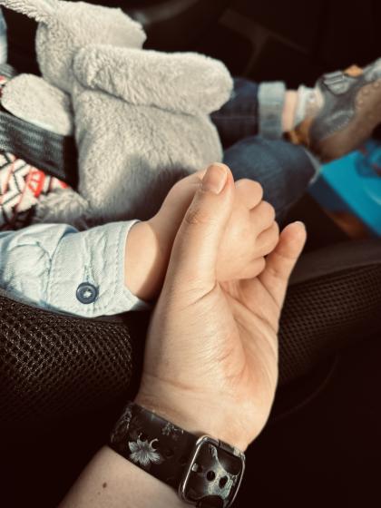 Grace holding her child's hand.