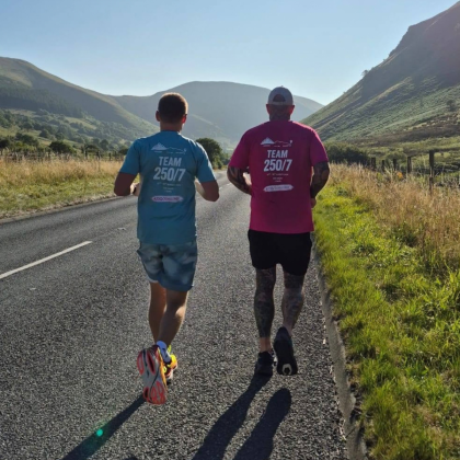 Adam runs with his friend Sam during his seven ultramarathons challenge.