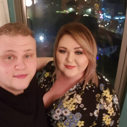Edd and Sophie smiling to camera.